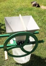 Manual Apple Crusher with Heavy Flywheel, Stainless Steel Hopper and Cutting Blades - on a bucket